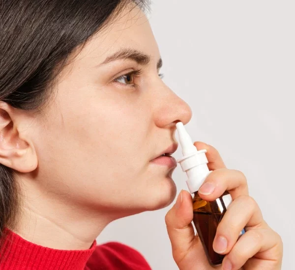 woman using nasal spray for ketamine treatment nyc